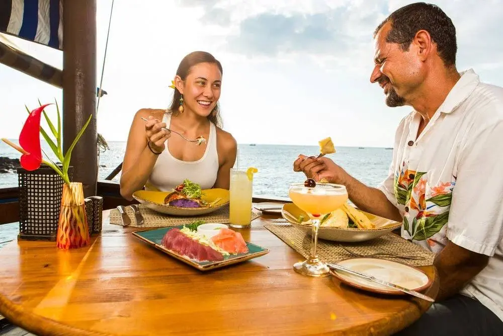 Couple dining at sunset at Huggo's