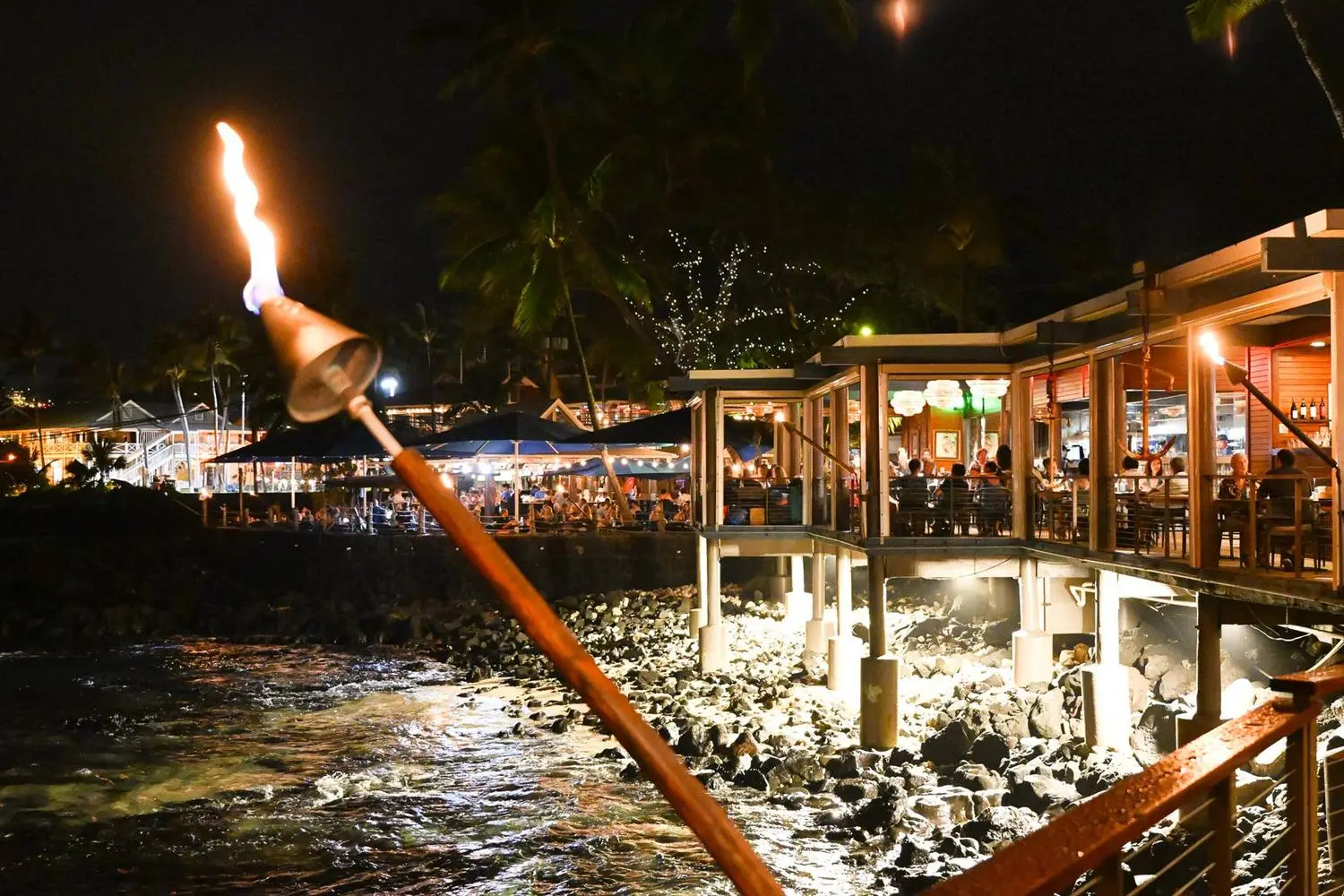 Torchlight over the rocks at Huggo's after dark