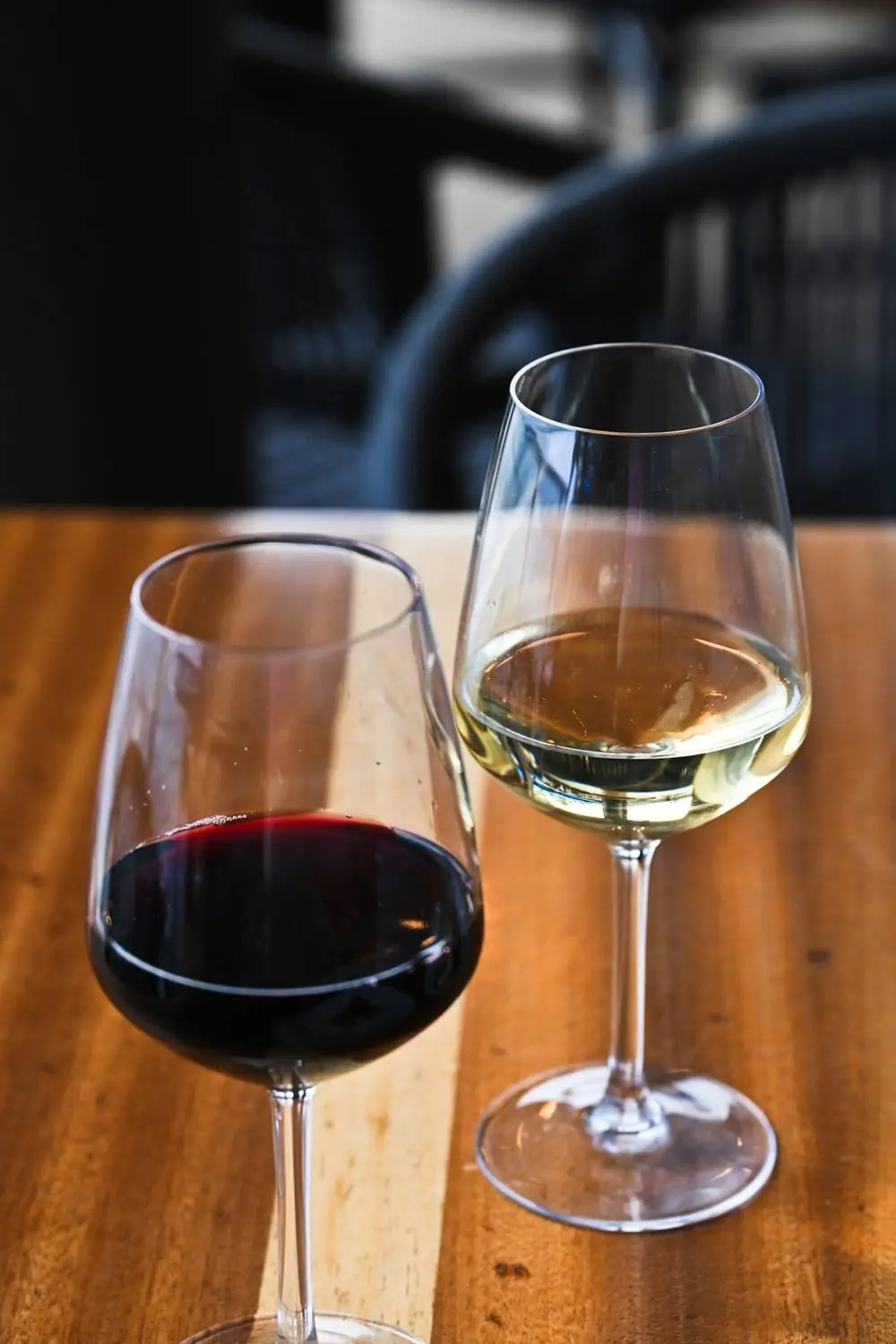 Red and white wine poured at the table